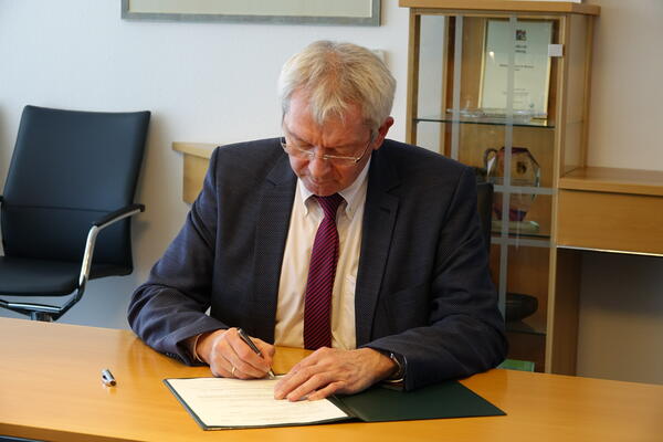Landrat Johann Kalb unterzeichnet die erste Auszahlung von Fördermitteln aus dem Rettungsschirm für Wirtschaft, Vereine und Verbände.